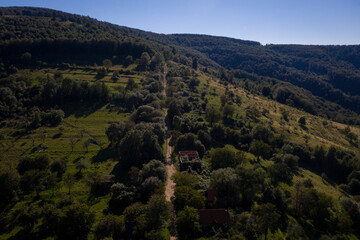 Aerial drone photograph with Lindenfeld deserted village in Semenic Mountains, Romania. The last inhabitant of the village, Paul Schwirzenbeck, died in 1998.