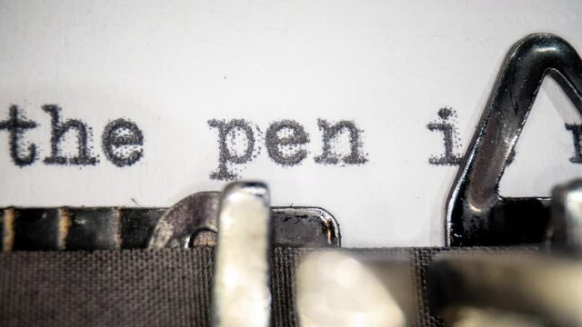 Vintage typewriter writing the pen is mightier than the sword