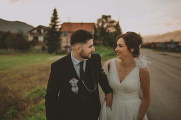 Bride and groom in a park kissing.couple newlyweds bride and groom at a wedding in nature green forest are kissing photo portrait.Wedding Couple