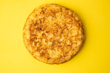 omelette with potatoes on yellow background