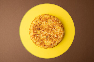 omelette with potatoes on brown background