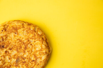omelette with potatoes on yellow background