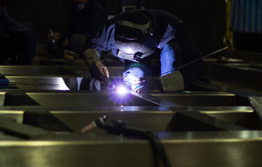 Metal workers use manual labor, Skilled welder, Factory workers making OT. Welder is welding the...