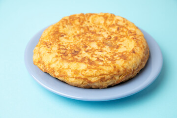 omelette with potatoes on blue background