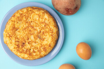 omelette with potatoes on blue background