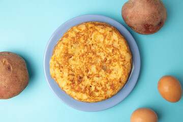 omelette with potatoes on blue background