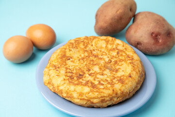 omelette with potatoes on blue background