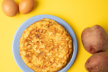 omelette with potatoes on yellow background