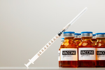 Sars-cov-2 vaccine vials and syringe on white background