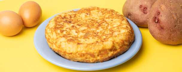omelette with potatoes on yellow background