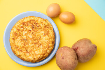 omelette with potatoes on yellow background