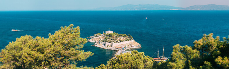 Fototapeta na wymiar Kusadasi, Aydin Province, Turkey. Top View Of The Pigeon Island. Old 14th-15th Century Fortress On Guvercin Adasi In The Aegean Sea. Bird Island