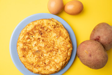 omelette with potatoes on yellow background