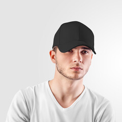 Mockup of a black baseball cap on a guy's head, front view, isolated on background.