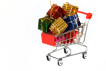 Metal shopping cart filled with colorful gifts on a white background. Advertising and sale. Holiday shopping in the supermarket.
