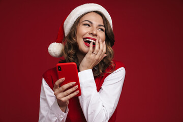Happy young woman in christmas santa hat