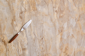 spreading knife on wooden surface