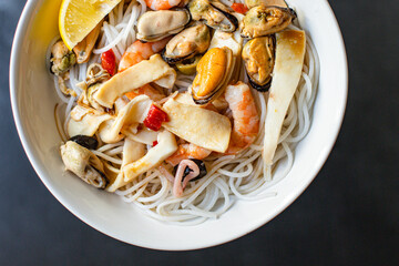 rice noodles seafood cellophane pasta shrimp, mussels, squid ingredient for preparing healthy meal snack top view copy space for text food background rustic