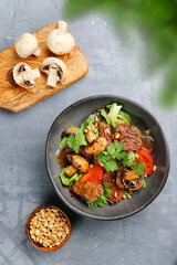 beef and champignons with pine nuts top view. beef and mushrooms salad on concrete table