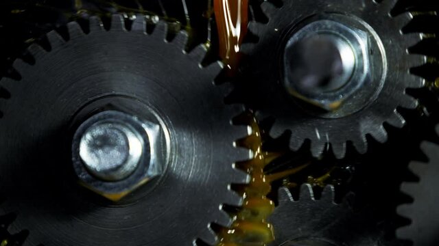 Super slow motion of rotating engine steel wheels with oil splashes. Filmed on high speed cinema camera, 1000 fps.