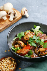 beef salad with mushrooms, pine nuts and tomatoes. salad with ingredients top view
