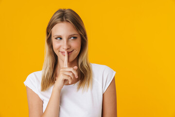 Happy beautiful girl smiling and showing silence gesture