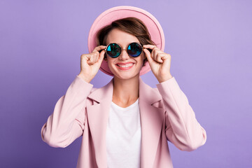 Photo of beaming young woman wear vintage outfit hands glasses isolated purple color background
