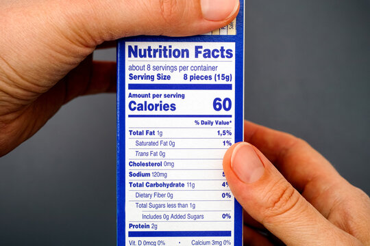 Nutrition Facts On Food Box In Woman Hands