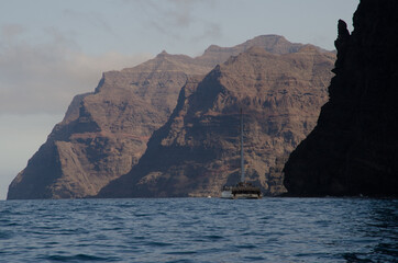Catamaran and sea cliffs in the Special Natural Reserve of Gui Gui. Aldea de San Nicolas de...