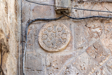 Decorative  pattern carved in stone on the wall in the Muslim part of the old city of Jerusalem in Israel