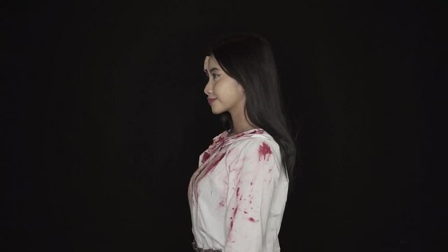 The ugly young woman stayed facing sideways showing her skin. With half of his face covered in blood wounds, and clothes covered in fresh blood.