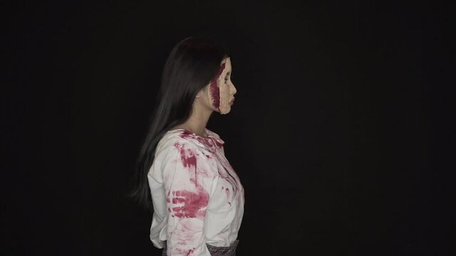 The ugly young woman stayed facing sideways showing her skin. With half of his face covered in blood wounds, and clothes covered in fresh blood.