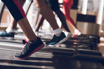 Feet running on a treadmill synchronously. 