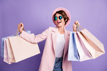 Photo of sweet pretty optimistic brunette young lady carry shop bags wear glasses pink cap coat...