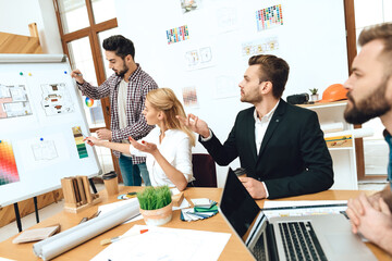 People are sitting at the table and discussing. 