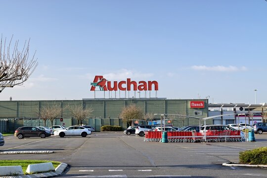 Leers,FRANCE-January 19,2020: View of Auchan supermarket logo and parking.Auchan is a French international supermarket chain, is one of the largest distribution groups in the world.