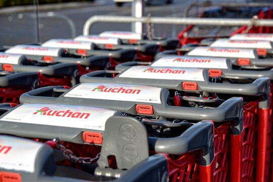 Leers,FRANCE-January 19,2020 : Close-up modern shopping trolleys Auchan hypermarket.Auchan is a French international supermarket chain, is one of the largest distribution groups in the world.