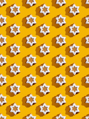 Star pattern. Orange seamless background. White gingerbread biscuit minimalist symmetrical composition wallpaper for kids. Modern contrast ornament isolated on bright yellow.