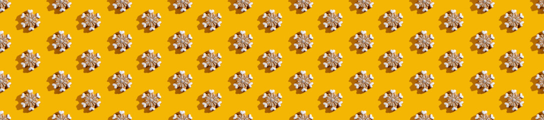 Yellow seamless background. White snowflake pattern. Minimalist symmetrical decorative composition for kids. Cute ornament isolated on bright orange wallpaper.