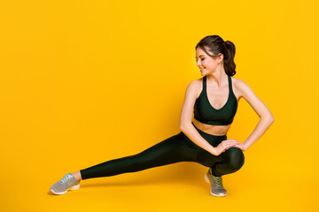 Fototapeta na wymiar Full length body size view of her she nice attractive focused cheery girl doing physical exercise shaping isolated on bright yellow color background