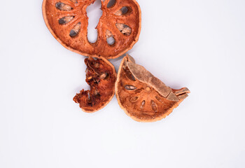 Sliced bael fruit,dried herb,put on background