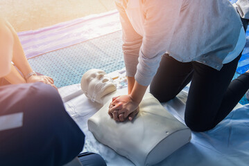 CPR training medical procedure – Demonstrating chest compressions on CPR in the class. - obrazy, fototapety, plakaty