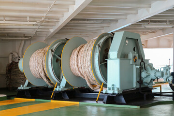 Mooring winch of large ship with rope in drum and Stern ship during moored alongside in port.