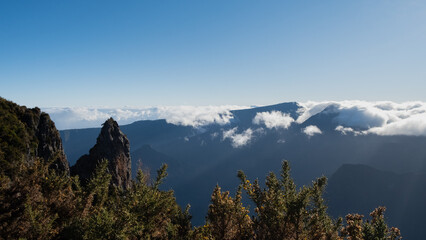 Panoramic view over the mountains of Reunion Island with briar, and a blue sky