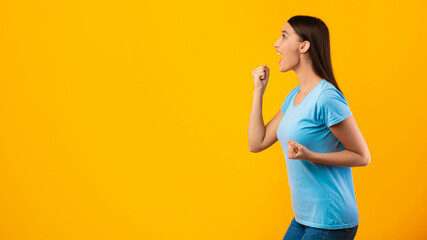 Portrait of cheering lady looking at copy space