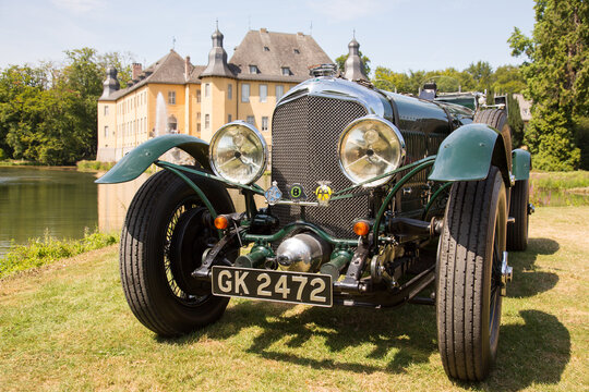 Jüchen, Germany - August 2019. Front view of a rare 1929 Bentley Super Six in a park with a Schloss Dyck castle backdrop. 
