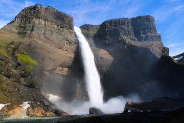 The beautiful Haifoss waterfall in the Icelandic Highlands on a wonderful day with sunshine and blue sky in summer