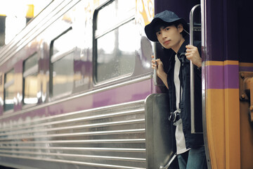 Asian travelers man and camera in train station