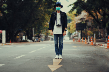 Asian travelers men and camera in train station with medical face mask to protection the Covid-19, new normal lifestyle