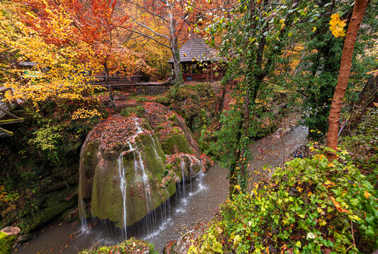Bigar Waterfall in the Romanian mountains - amazing view of one of the most beautiful waterfalls in Europe during an autumn day with great fall colors